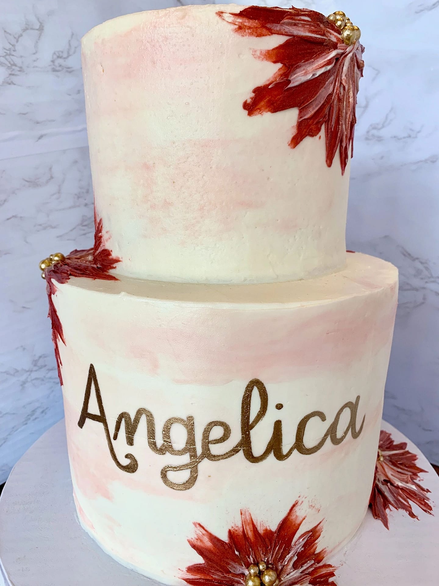 Handpainted buttercream floral two-tier cake maroon and blush.